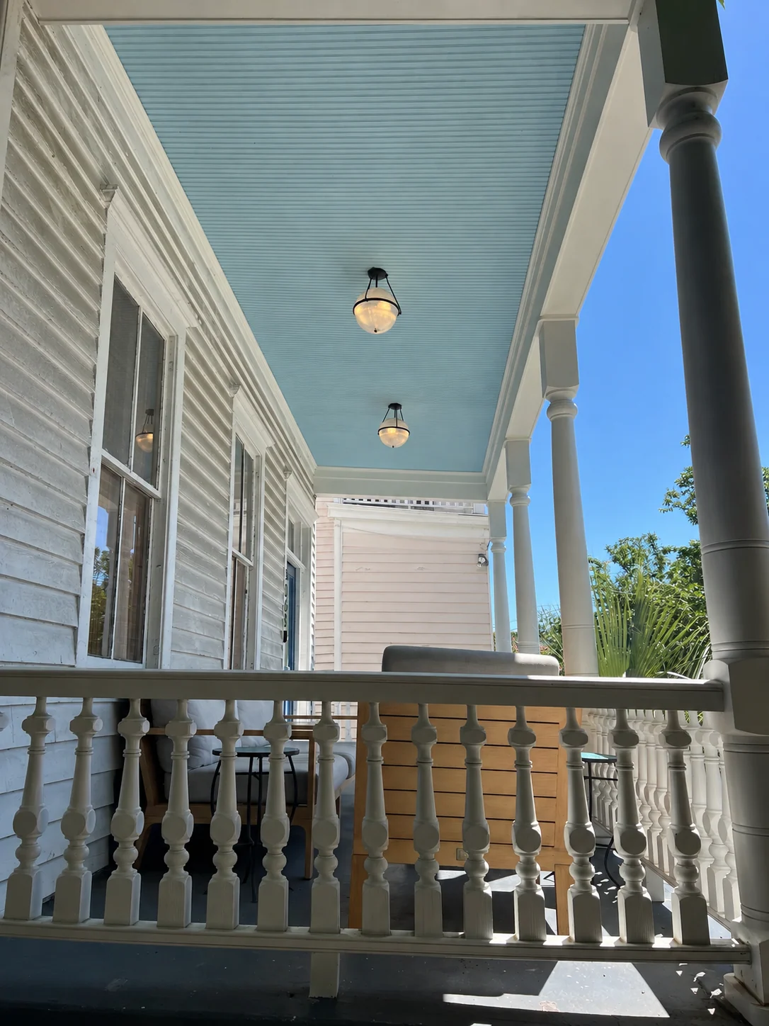 Finished blue porch ceiling and white trim on a historic Charleston home